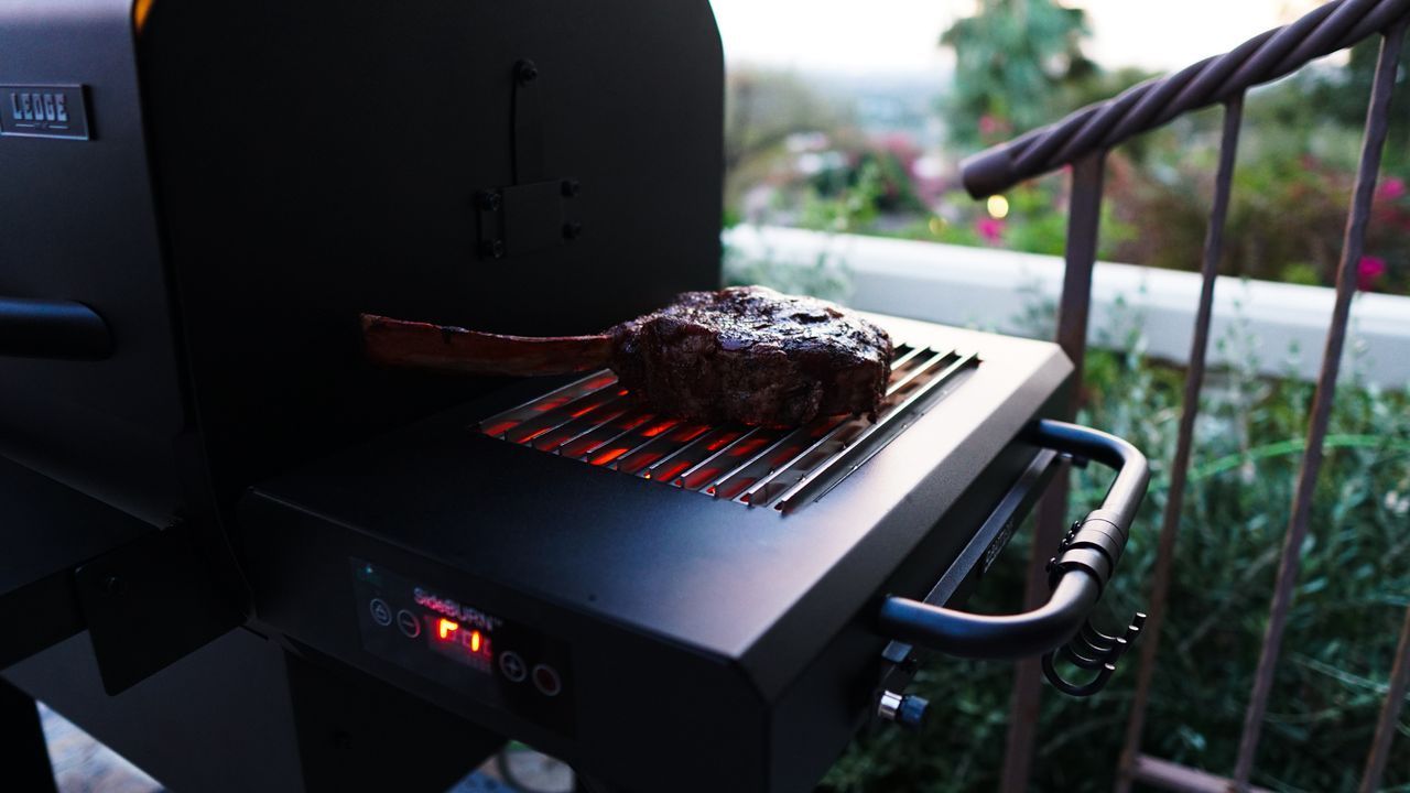 A large piece of meat is cooking on a grill.