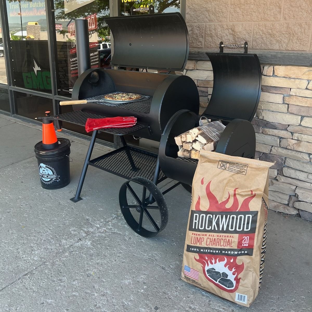 A bag of rockwood is sitting next to a grill