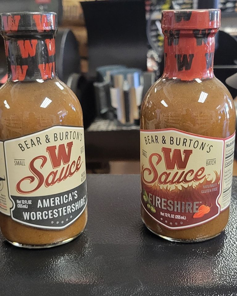 Two bottles of bear & burton 's w sauce are sitting on a table