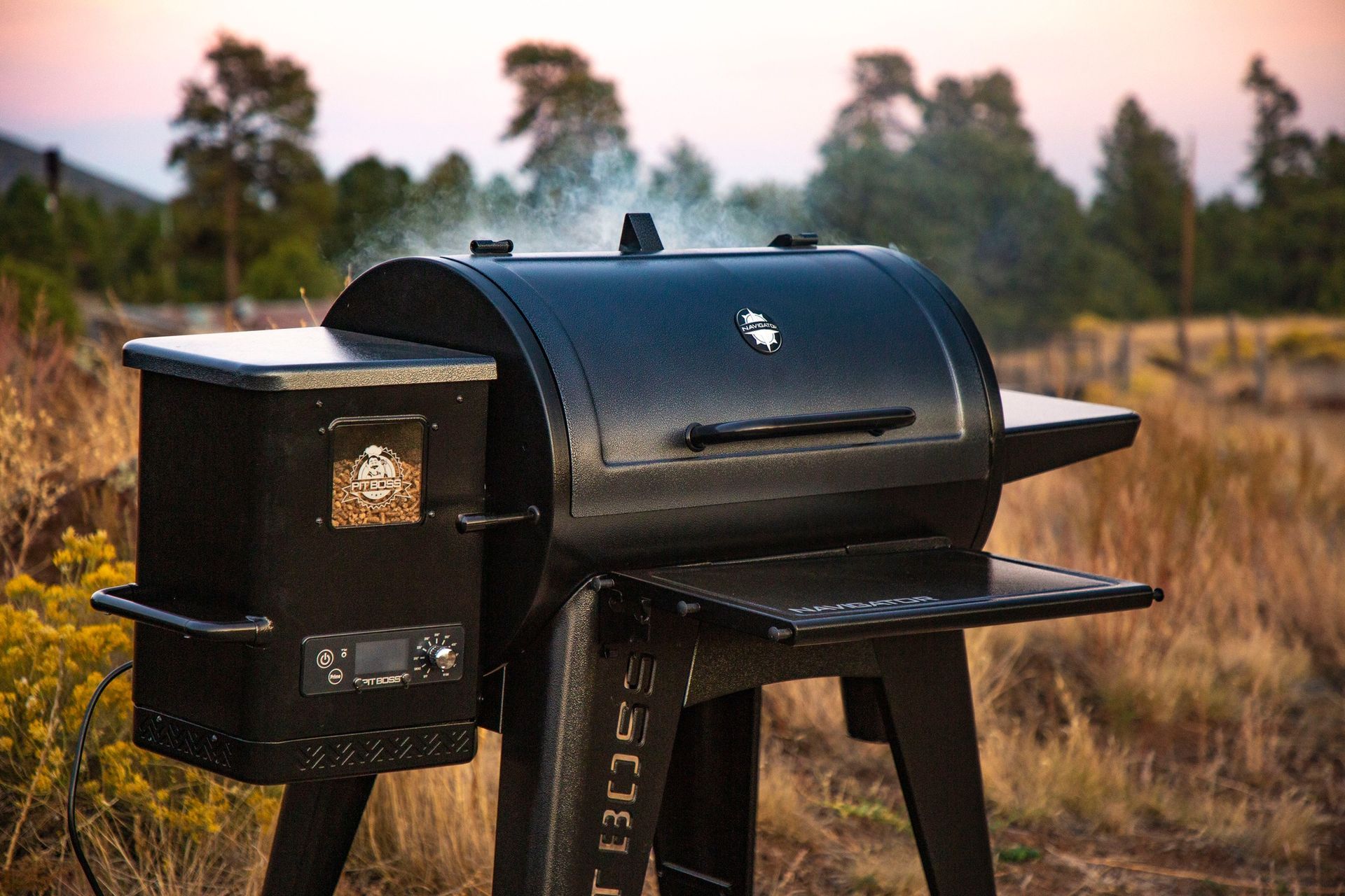 A black grill is sitting in the middle of a field.