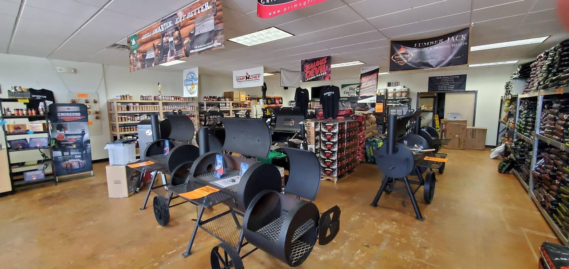 A large room filled with lots of grills and chairs.