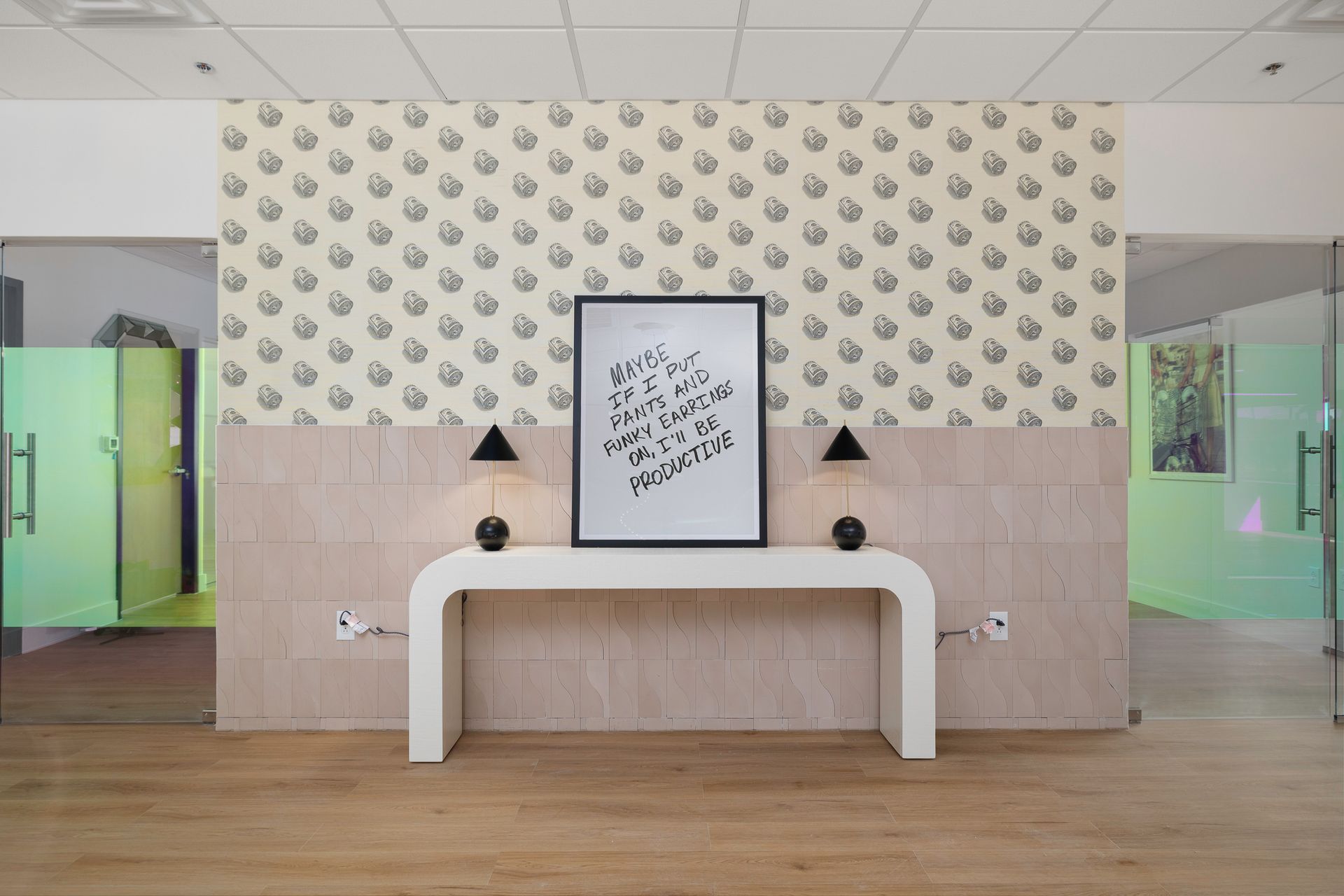 A room with a table and a picture on the wall.