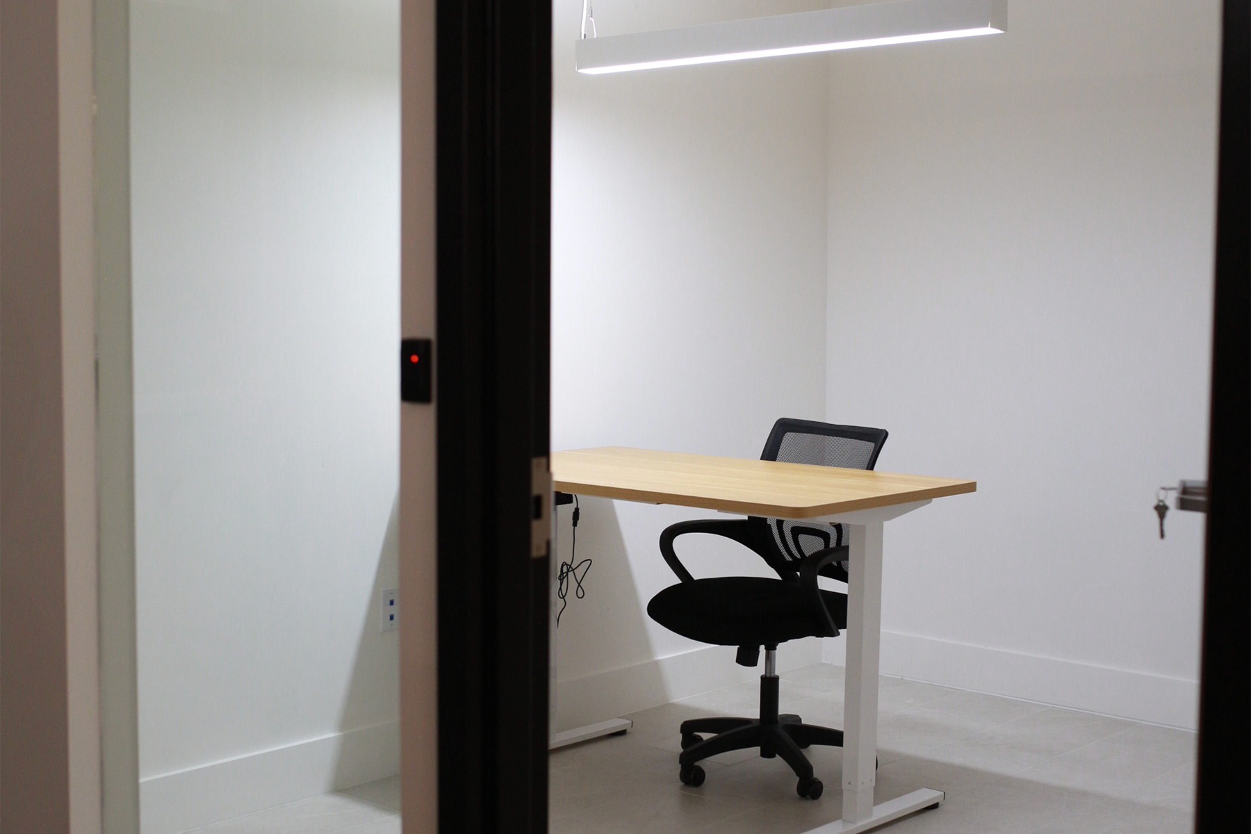 A room with tables and chairs and a long counter.