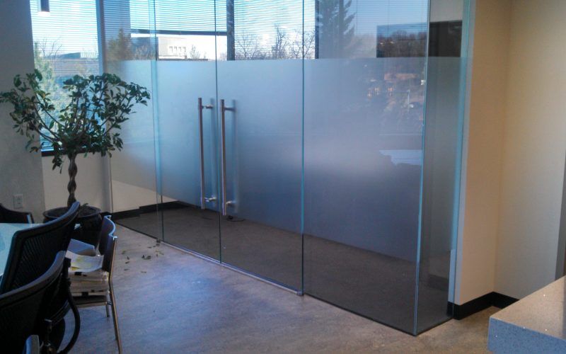 A room with sliding glass doors and a plant in a pot.