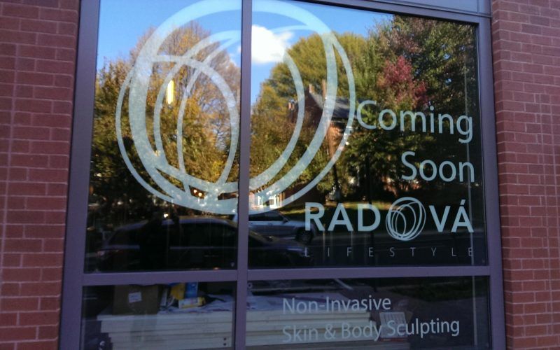 A sign on a window that says coming soon radova