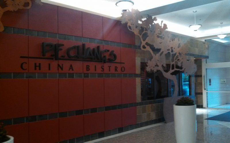 A sign for peaches china bistro is on a wall