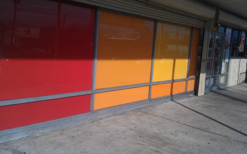 A red and yellow building with a sliding glass door