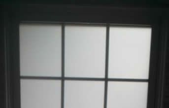 A close up of a window with a black frame.