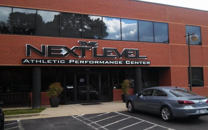 A car is parked in front of the next level athletic performance center