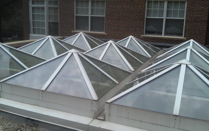 A row of pyramid shaped skylights on the roof of a building