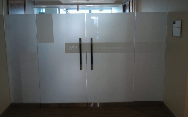 A glass door with a sticker on it that says ' a ' on it