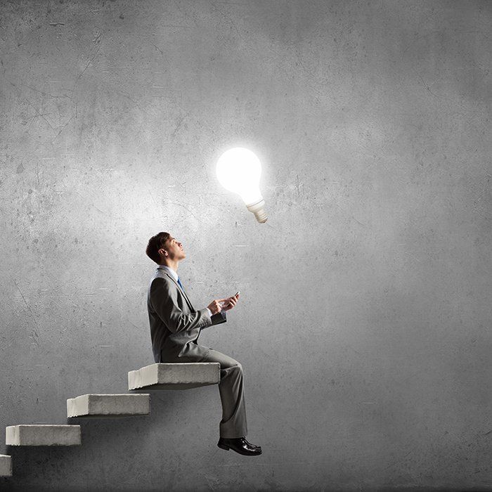 Strategic marketing concept - businessman looking at light bulb