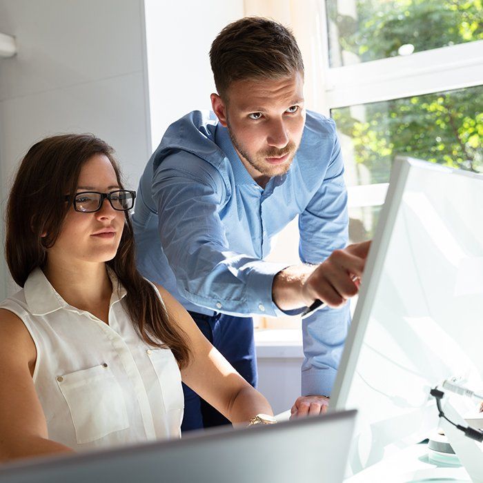 Woman receiving training on a computer
