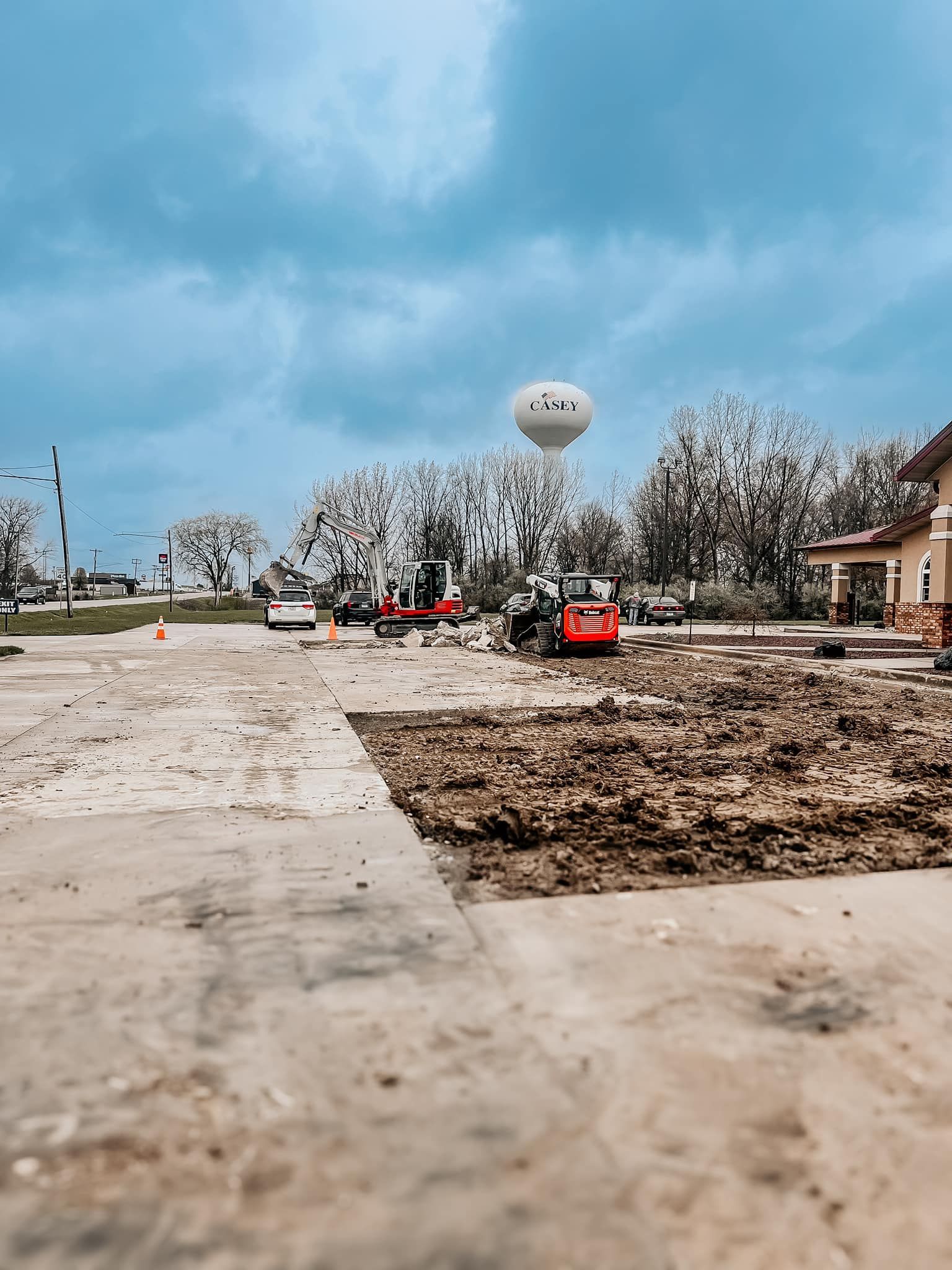 A construction site with a balloon flying in the sky.