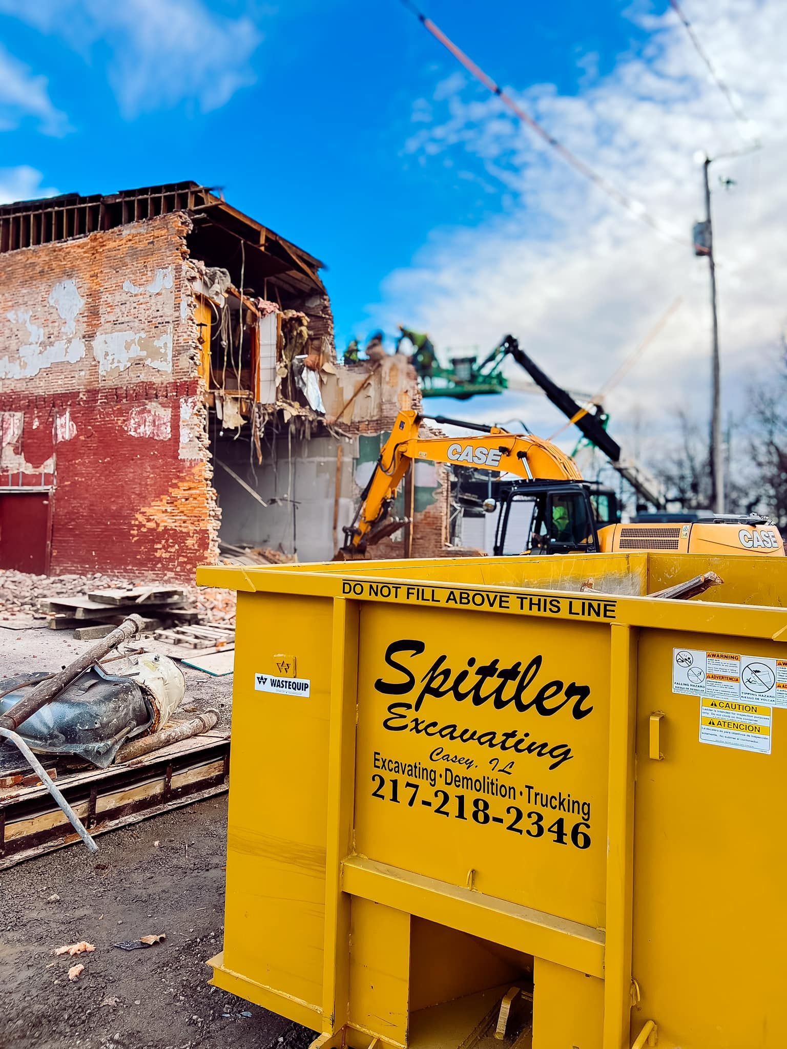 A yellow dumpster with the word spittler on it