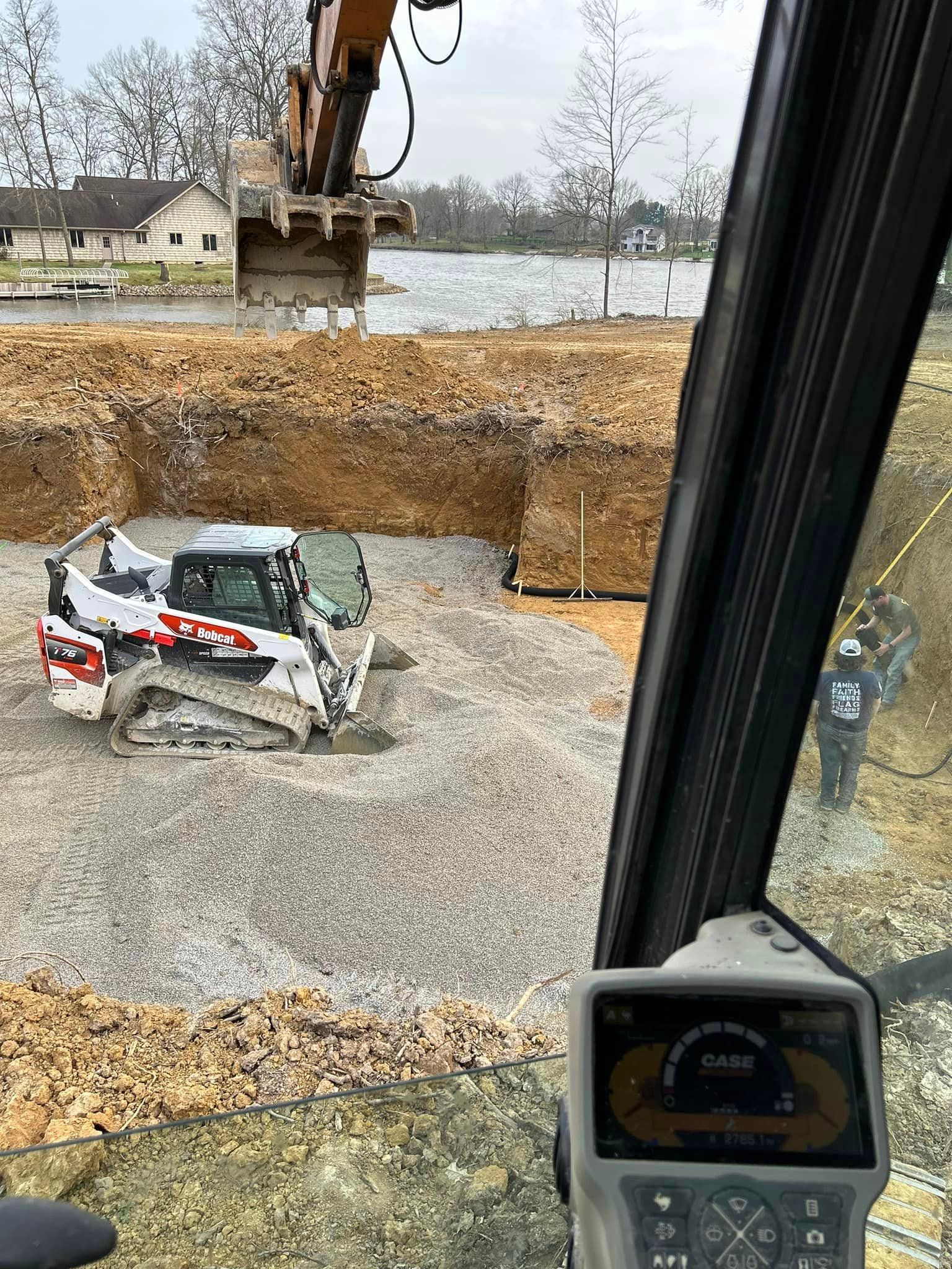 A bulldozer is digging a hole in the ground at a construction site.