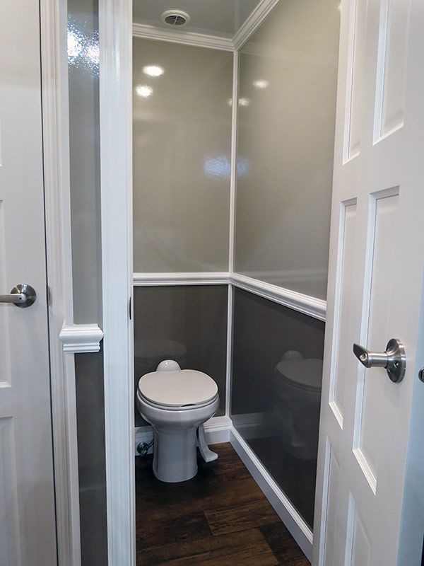 A small bathroom with a toilet and a door.