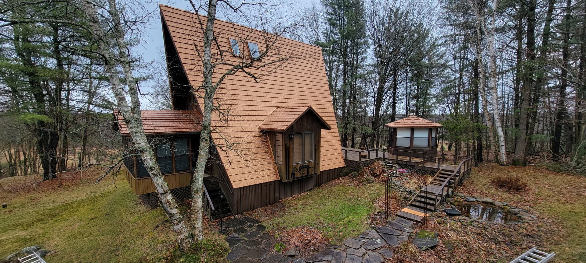 A small wooden house in the middle of a forest.