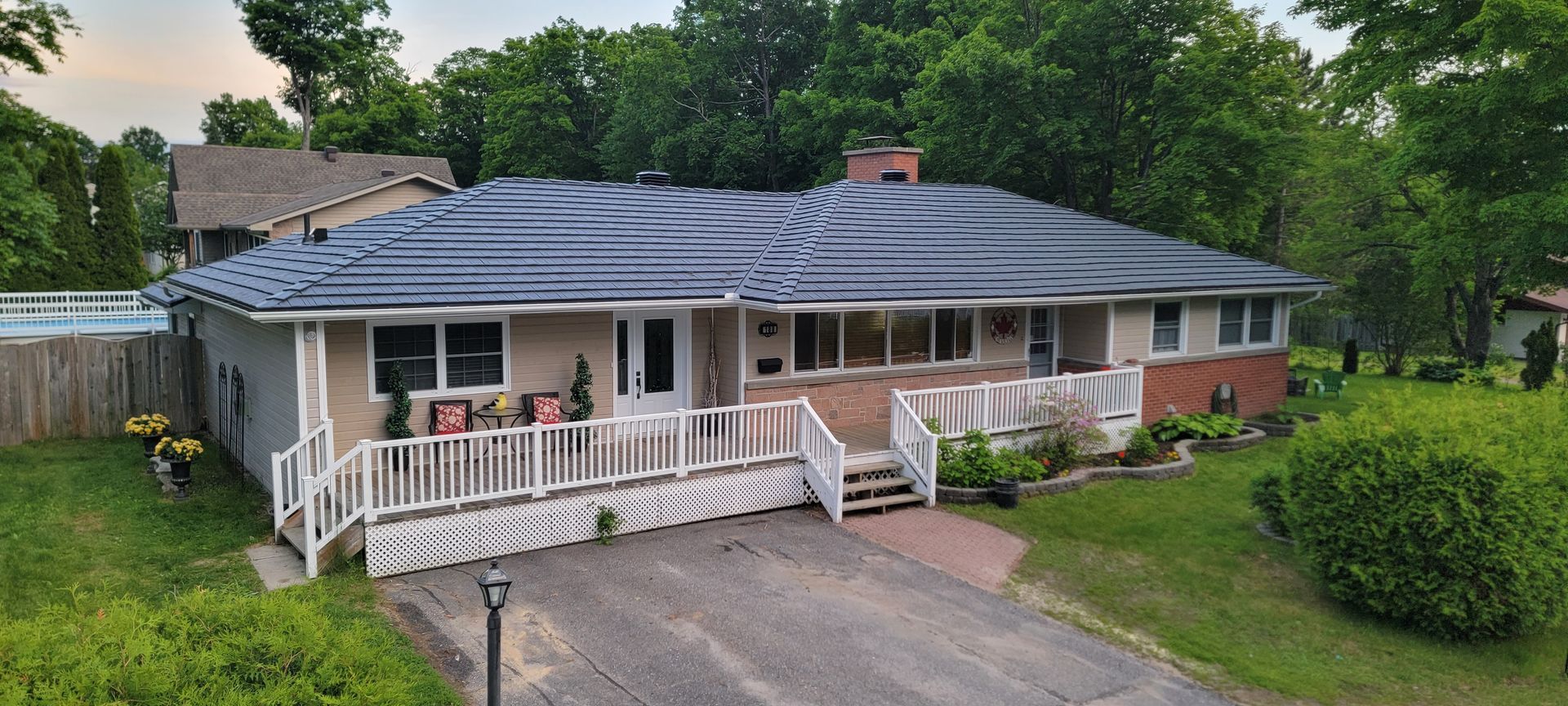 An aerial view of a house with a blue roof.