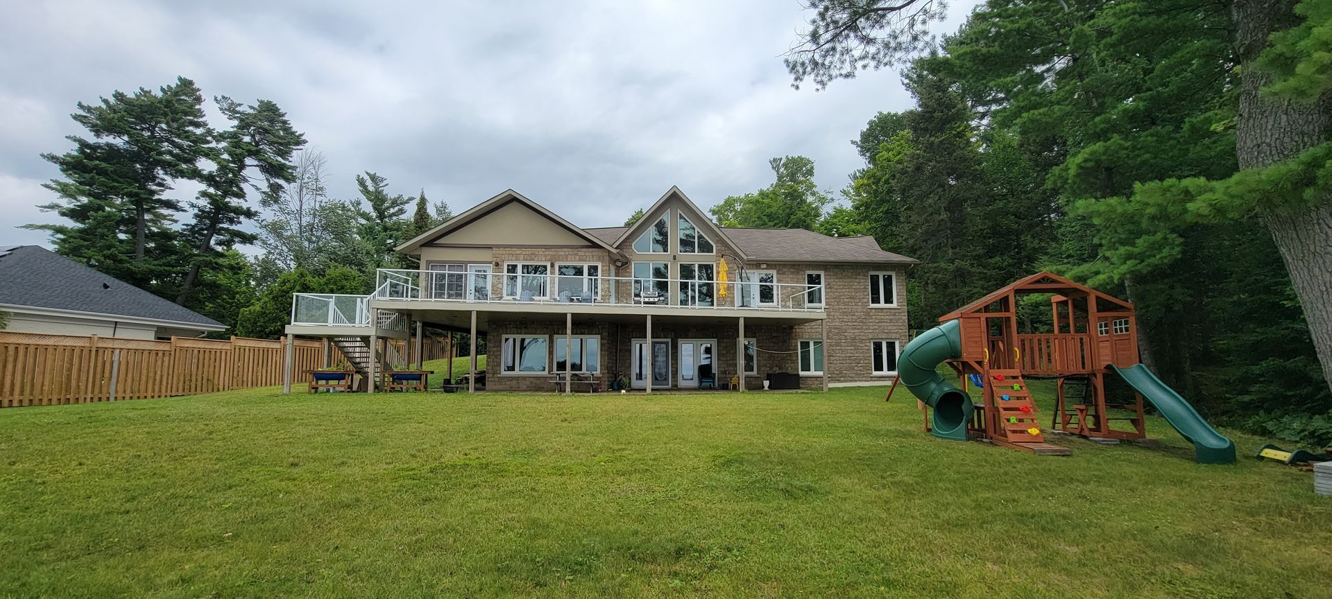 A large house with a playground in front of it.