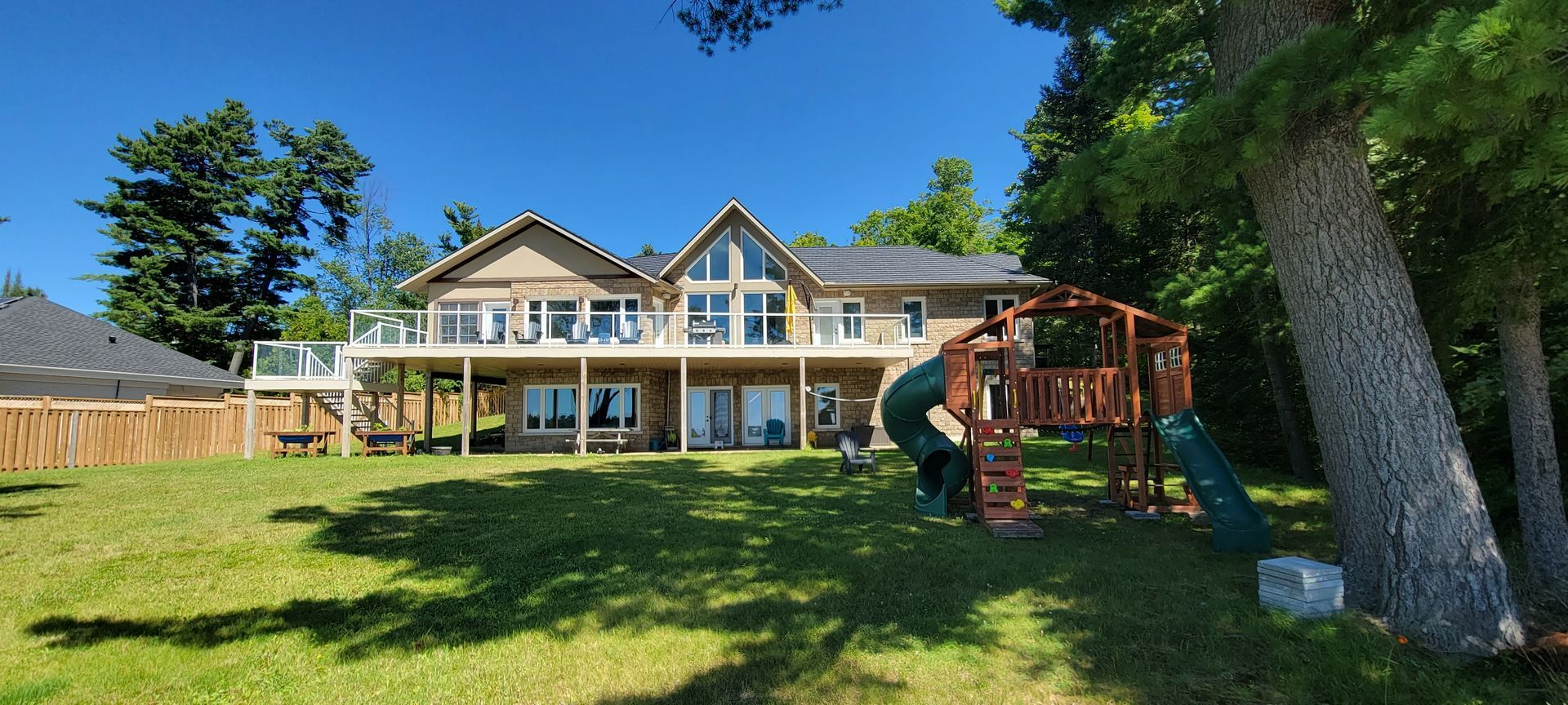 A large house with a playground in front of it.