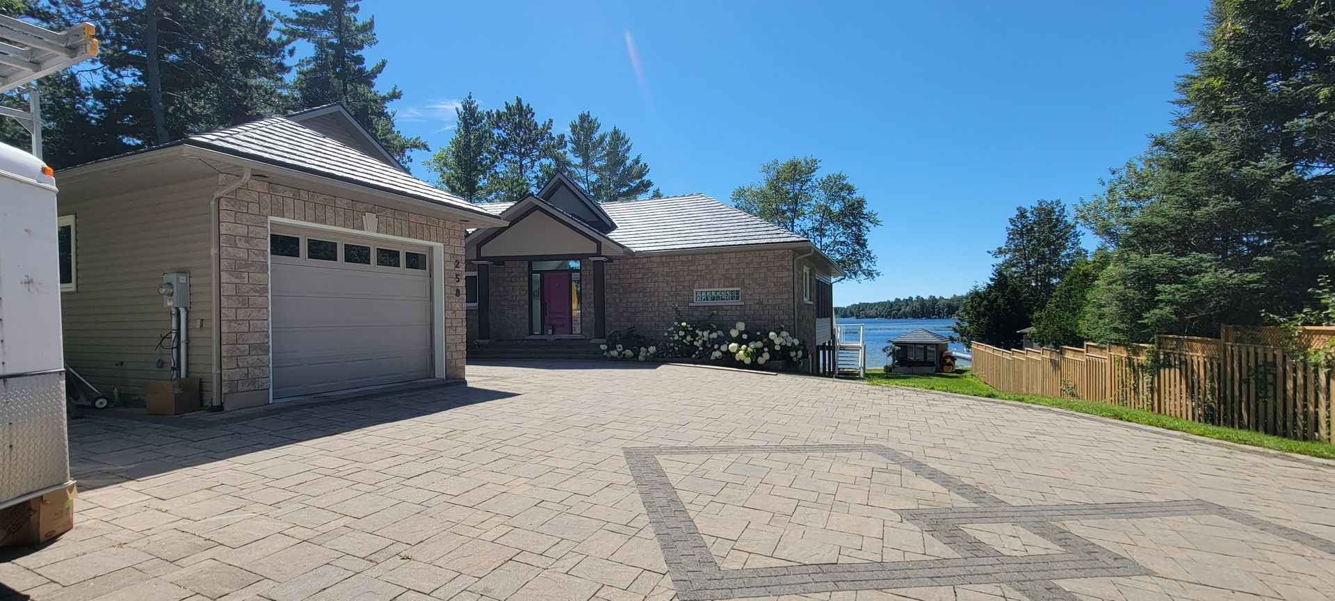 A large house with a garage and a driveway leading to it.