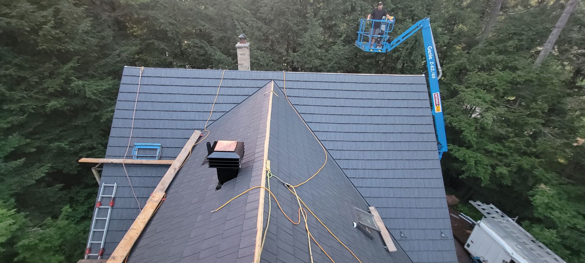 An aerial view of a roof being installed on a house.