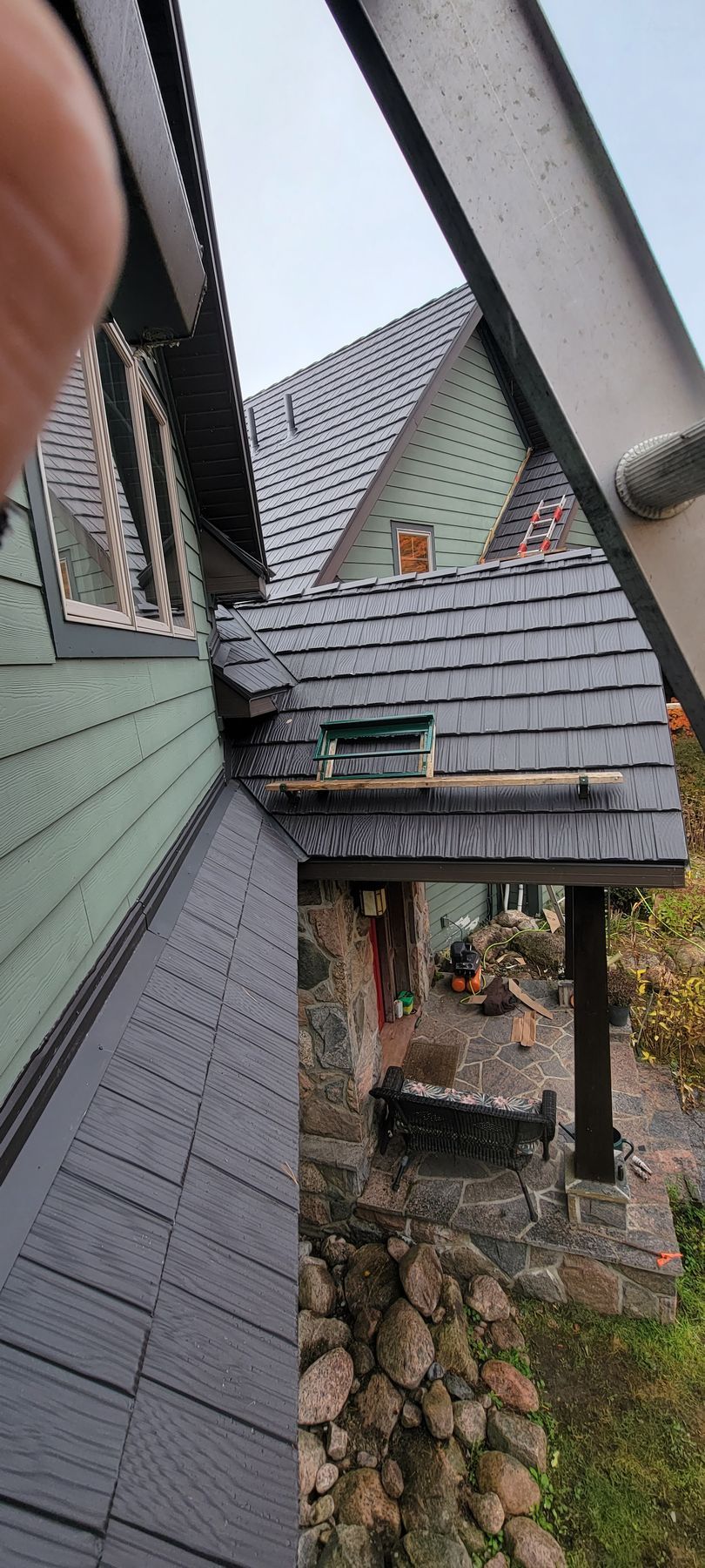 A person is looking up at a roof of a house.
