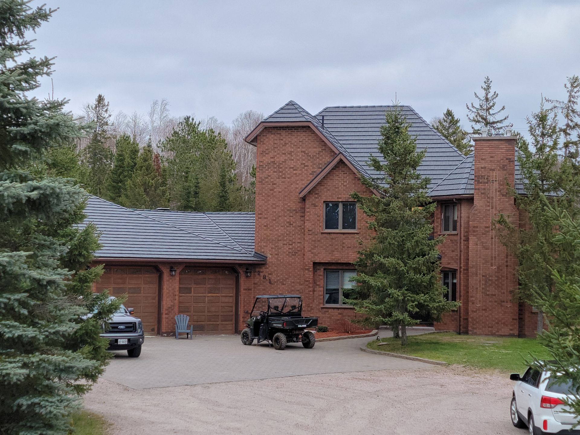A large brick house with a golf cart parked in front of it