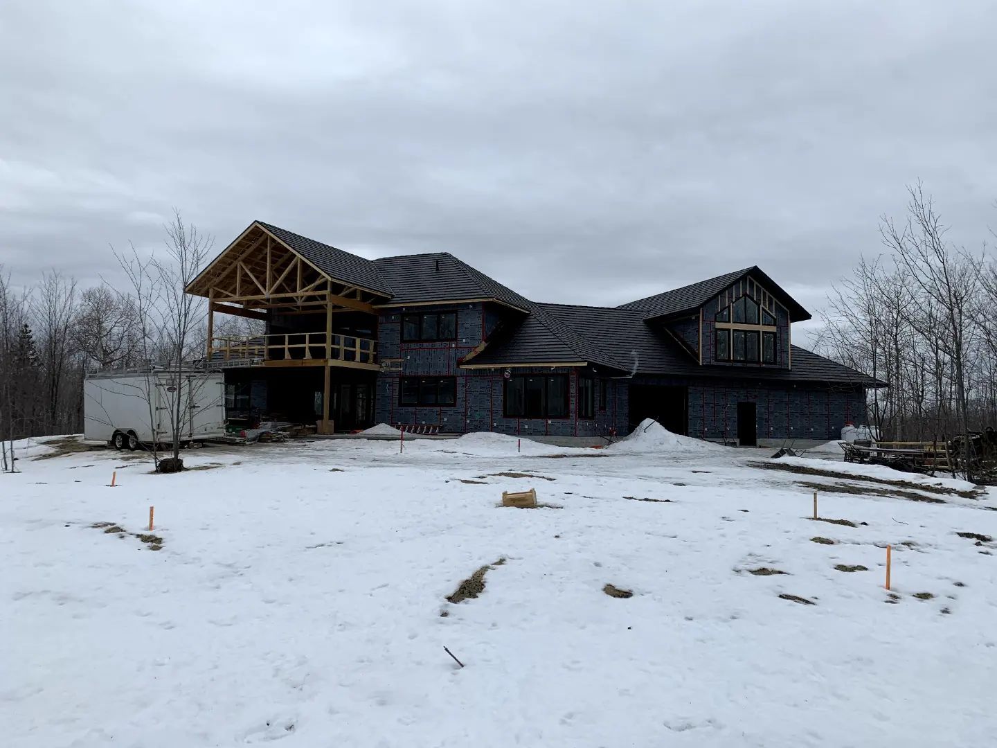A large house is being built in the snow.