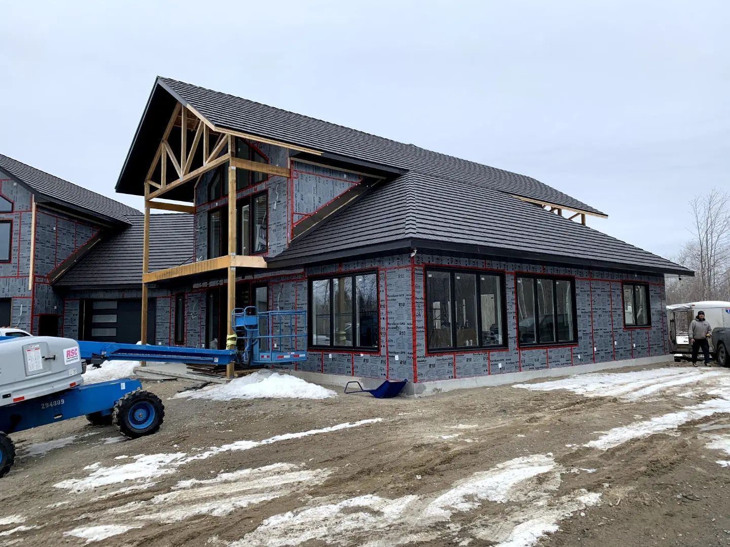 A large house is being built in the snow.