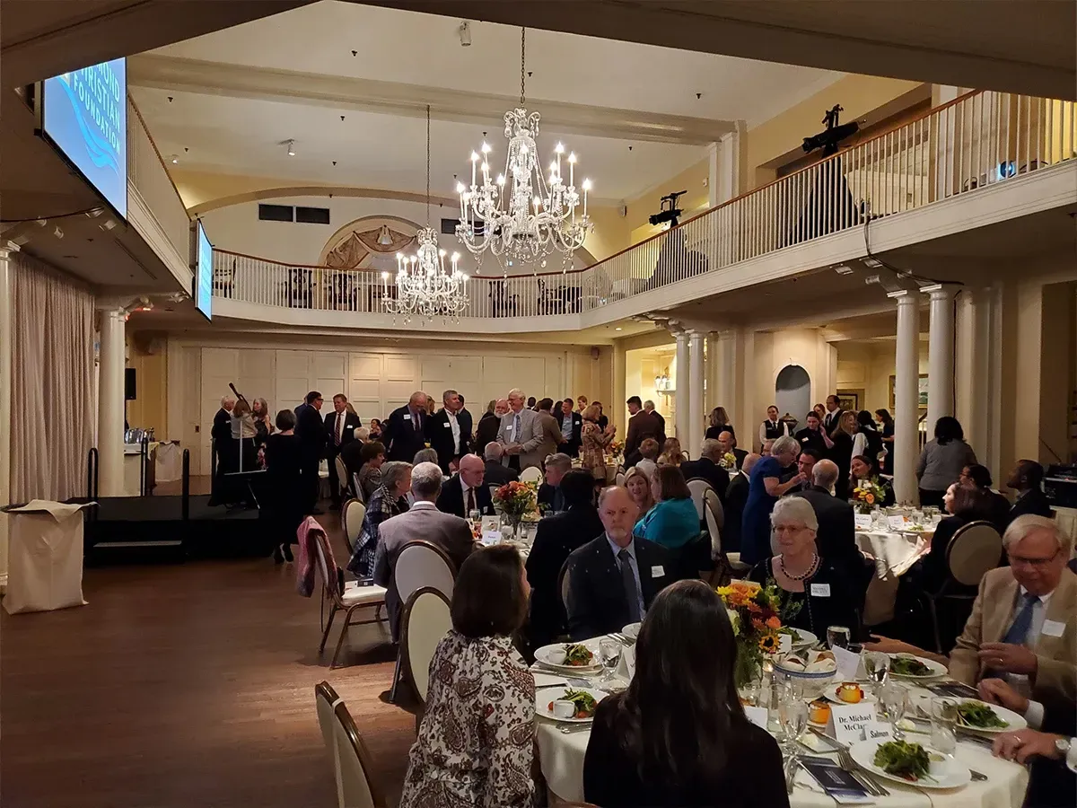White rocking chair overlooking green grounds during a Richmond Christian Foundation event