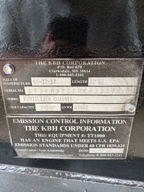 Black metal plate with manufacturer information: The KBH Corporation, equipment model TT1000, emission standards met.