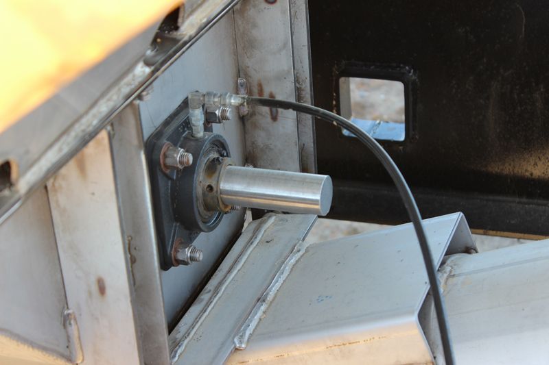 A close up of a metal object with a cable attached to it