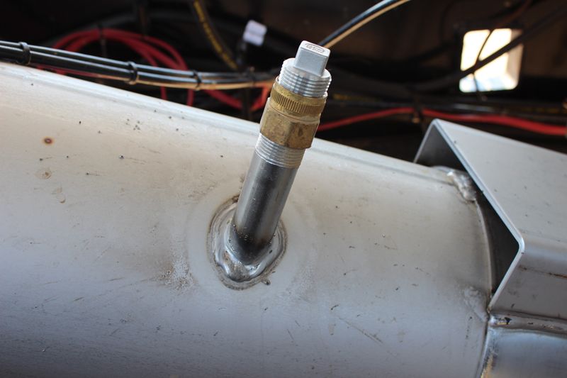 A close up of a metal pipe with a screw in it