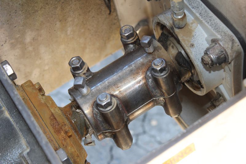A close up of a metal object with nuts and bolts on it