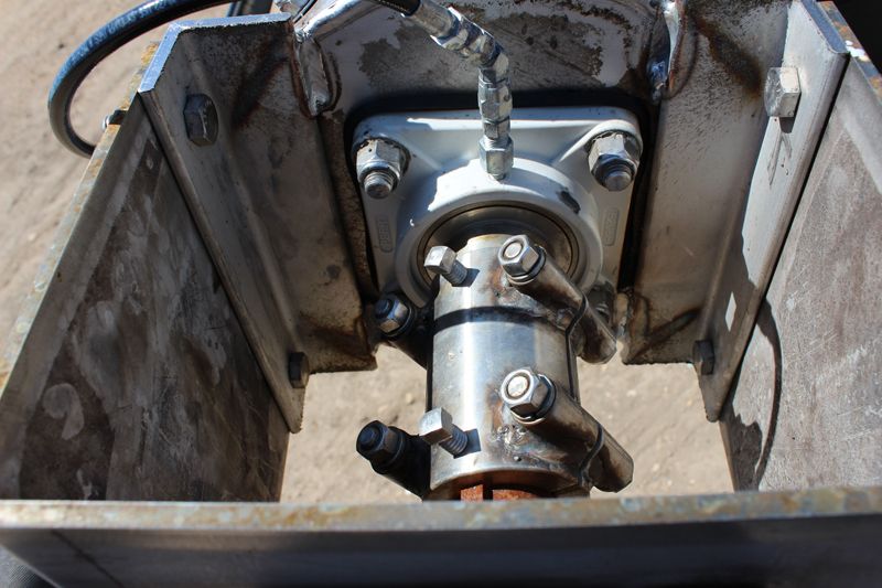 A close up of a metal object with a hose attached to it