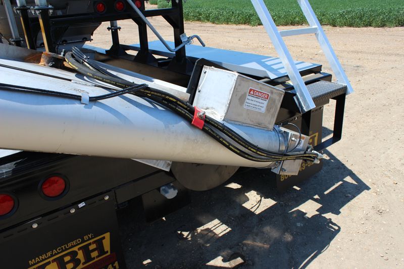 A ladder is attached to the back of a truck.