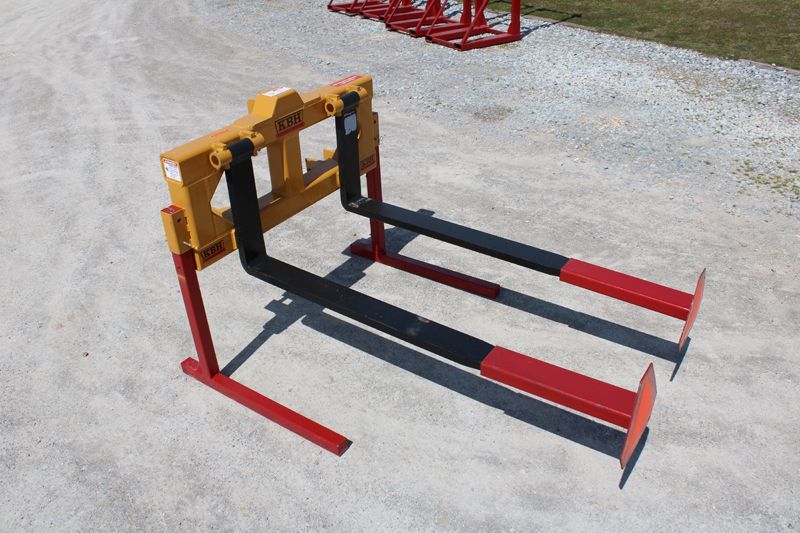 A pair of forks sitting on top of a gravel road.