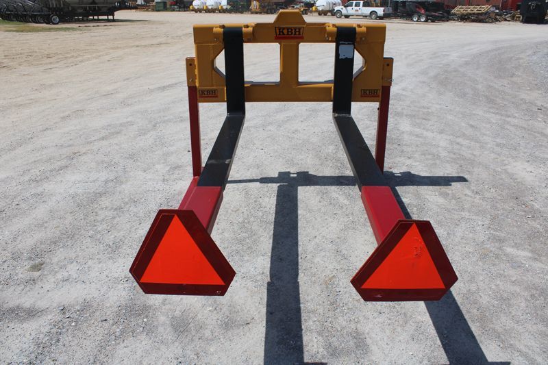 A yellow and red forklift with two orange triangles on it