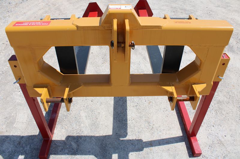 A yellow and red piece of equipment with a label that says ' tractor ' on it