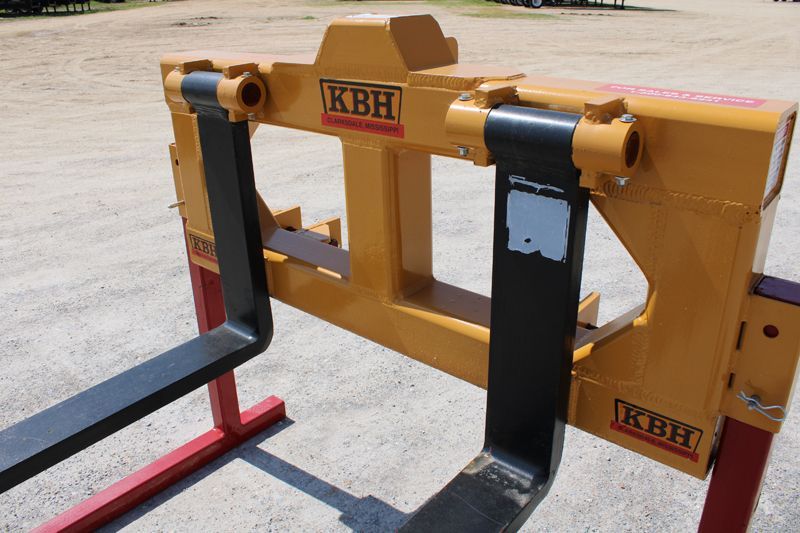 A yellow and black forklift with kbh written on it
