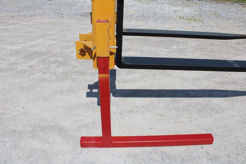 A yellow and black forklift with a red base