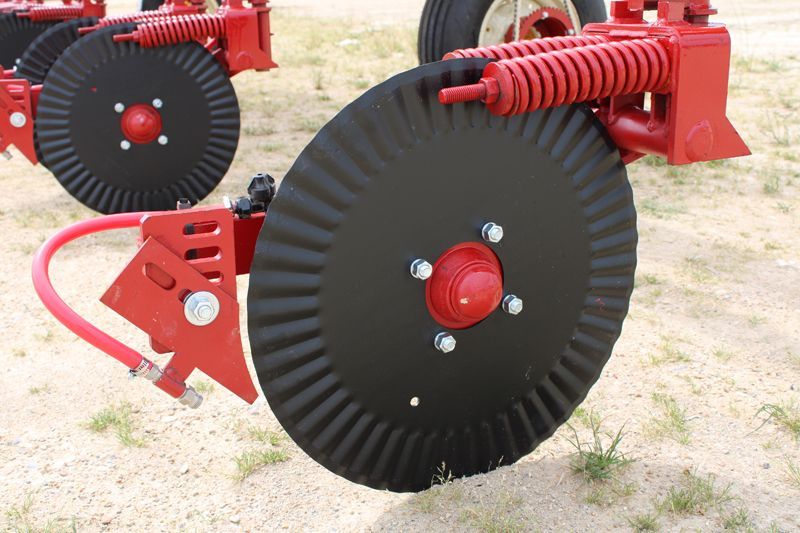 A close up of a red and black tractor wheel