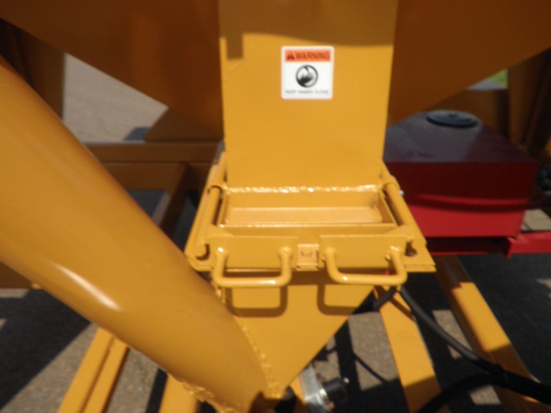 A yellow machine with a warning sign on it