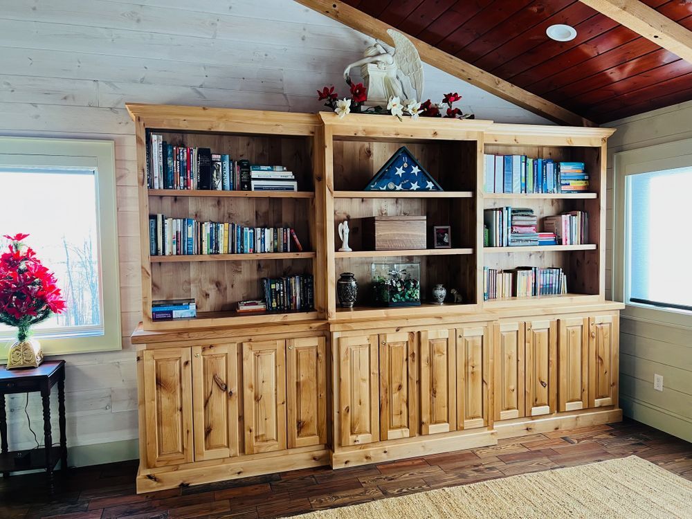 Wooden bookshelves filled with books and decorations.