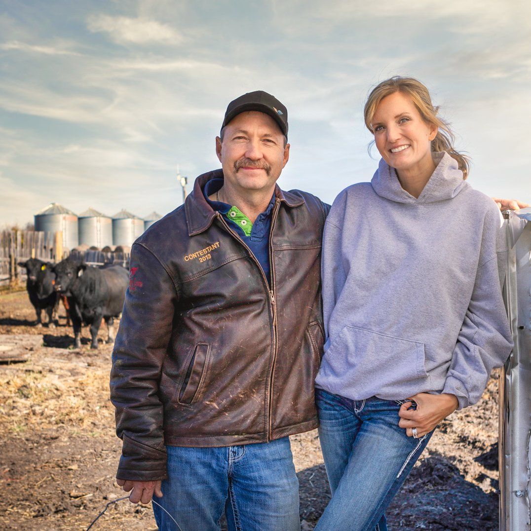 Steve and Jaclyn Friend smiling on their ranch near Viking, Alberta