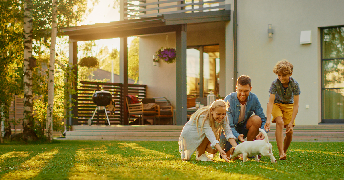Happy family outside their home.
