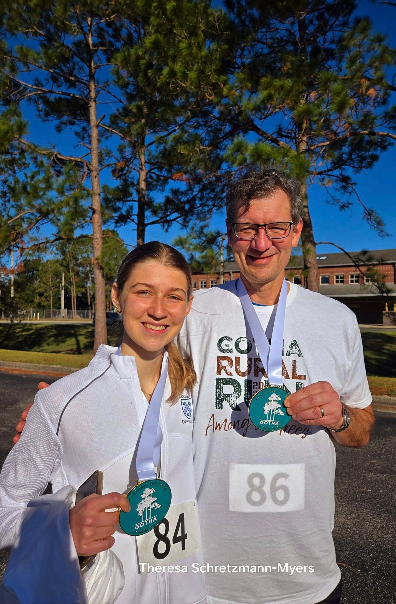 Zoe Richter and Rainer Richter show off their Gotha Rural 5K medals.