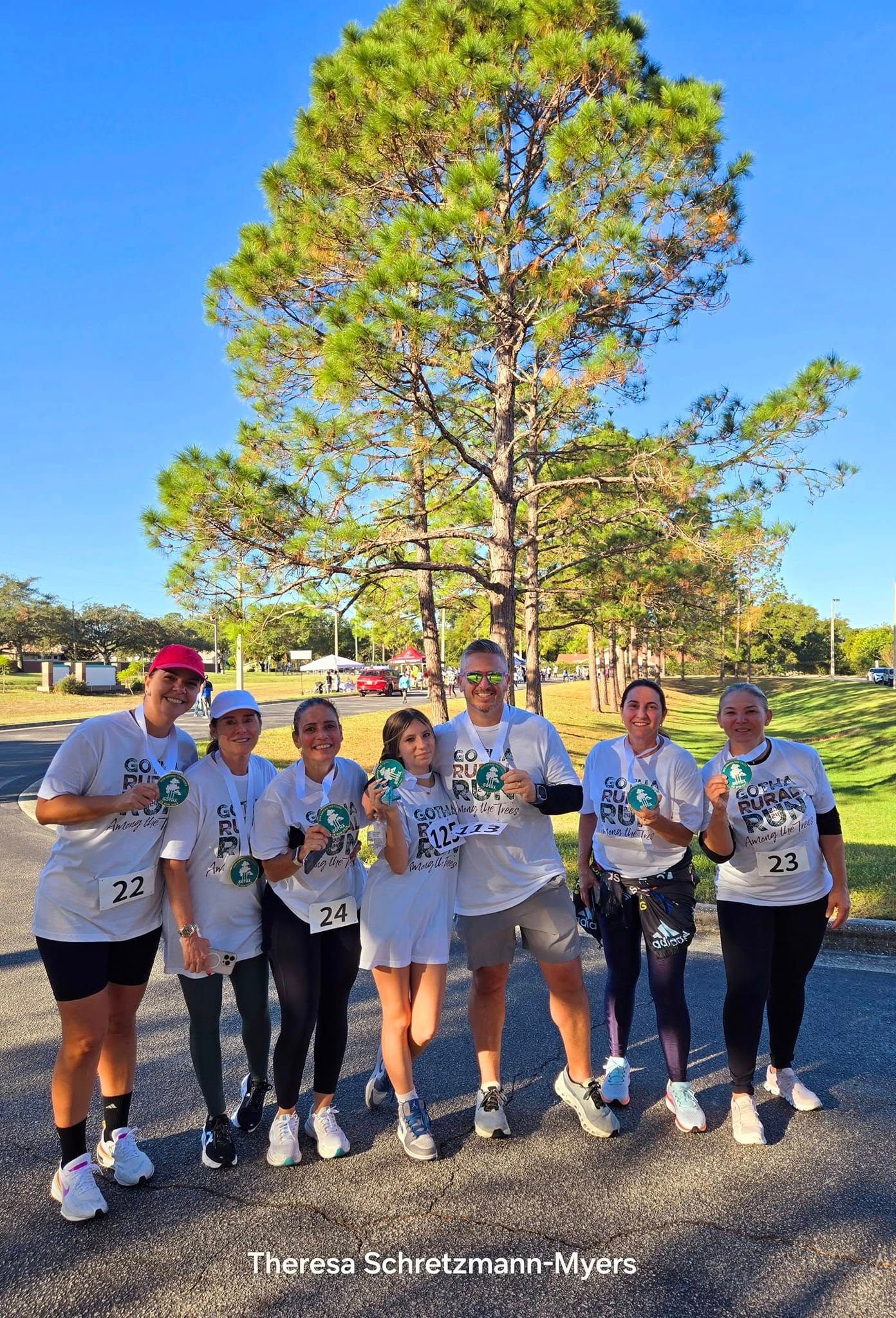 Our runners show their 5K medals at the Gotha Rural 5K Run